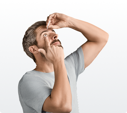 Actor portrayal of man applying YUVEZZI presbyopia eye drops